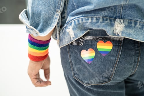 Preview: Asian lady with rainbow flag heart, symbol of LGBT pride month celebrate annual in June