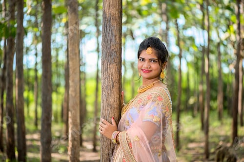 Preview: Portrait of beautiful bride wearing traditional clothing outside in nature.