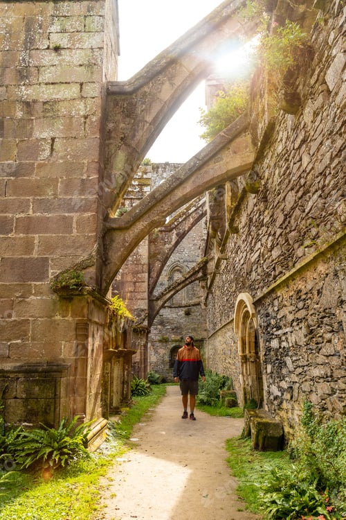 Preview: A young man visiting the interior gardens of the Abbaye de Beauport in the village