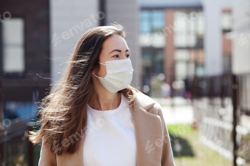 Preview: A young woman outside wearing a medical protective mask, virus covid-19 pandemic, social distancing
