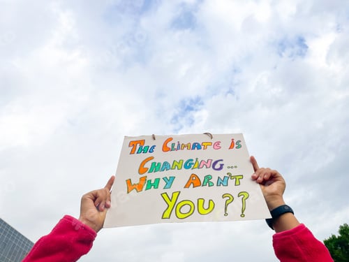 Preview: Hands holding sign about climate change