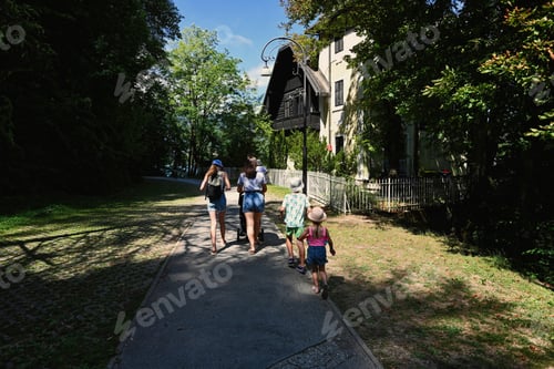 Preview: Family walking at park path in Bled, Slovenia.