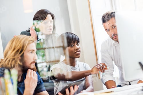 Preview: Design team looking at desktop computer in creative studio