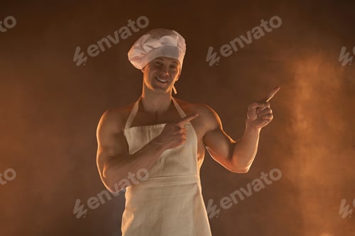 Preview: Chef Handsome muscular young guy in an apron and a chef's hat