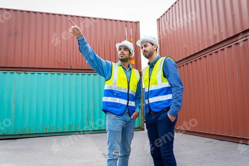 Preview: Two male engineers in a container shipping company