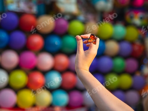 Preview: Person playing pop balloons with darts game