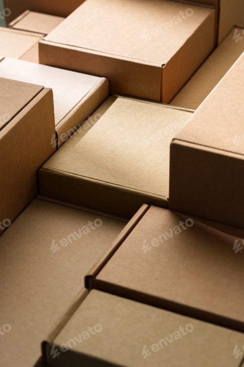 Preview: Stacked cardboard boxes arranged in a neat pattern under natural light