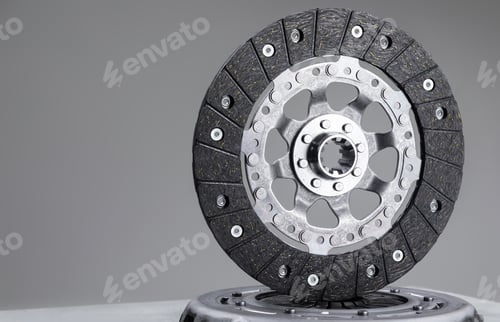 Preview: Car clutch plate on a gray background, new part, car warranty service