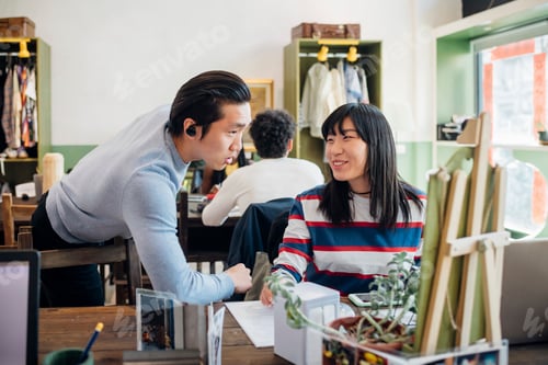 Preview: Young businesswoman and man talking at cafe table