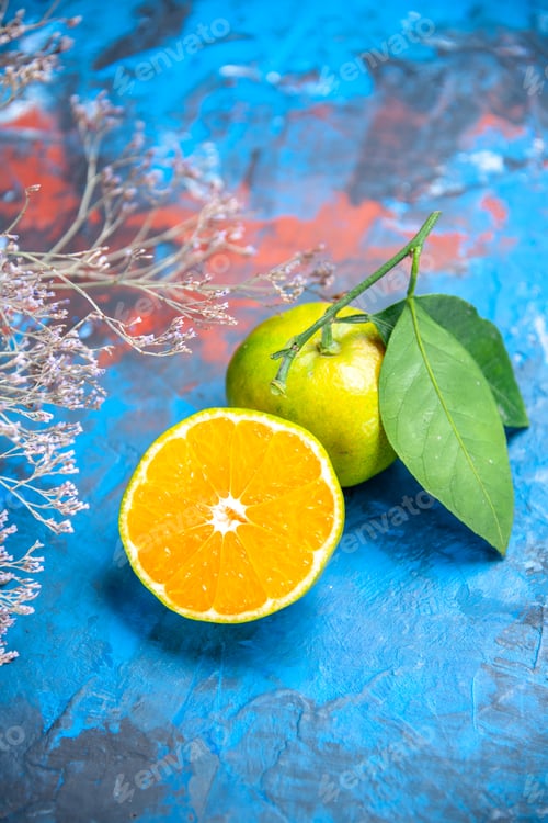 Preview: front view fresh mandarin with leaves cut mandarine on blue background free space