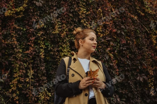Preview: Woman with Leaves in Front of Leafy Wall