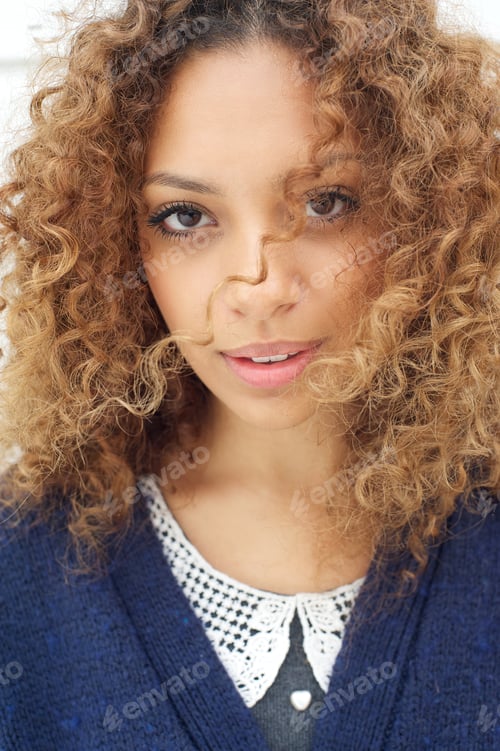 Preview: Female fashion model with wind blowing hair over face