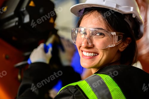 Preview: Happy female maintenance engineer worker working at industrial factory