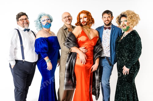 Preview: Group of happy drag queens and gay friends standing together looking at camera