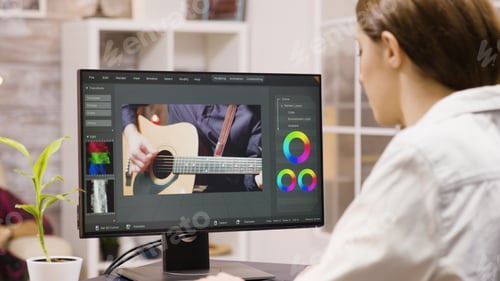 Preview: Over shoulder footage of female content creator working on a video