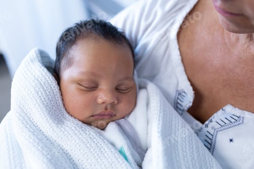 Preview: Close-up of Caucasian mother holding newborn baby in hospital