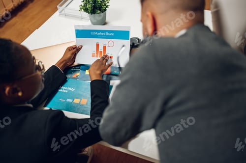 Preview: Business colleagues discussing chart document during a meeting