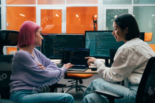 Preview: young programmers working on a new project for a start up business.