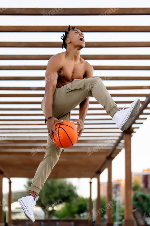 Preview: Multiracial person posing with basketball ball