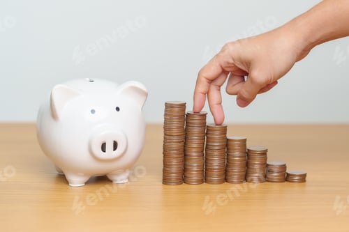 Preview: Fingers Walking Up Stacks of Coins to Piggybank