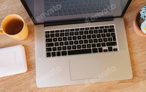Preview: top view of a desk with laptop, wooden table