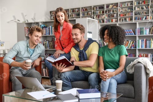 Preview: Group of young people studying at table in library