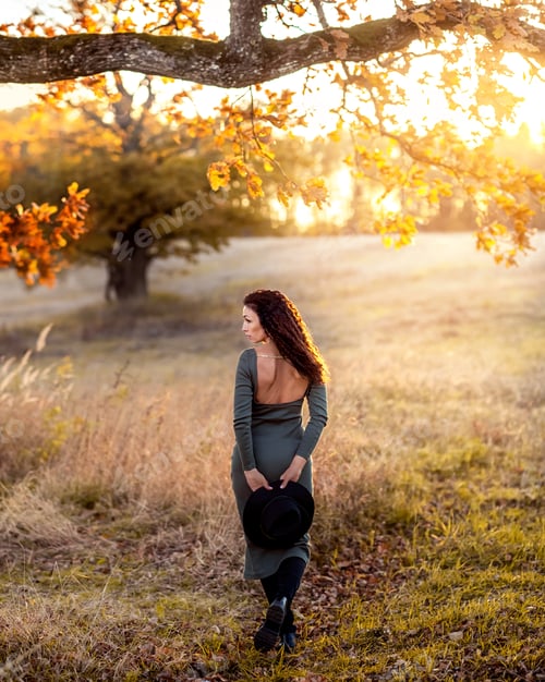 Preview: girl on the background of autumn nature. girl standing back