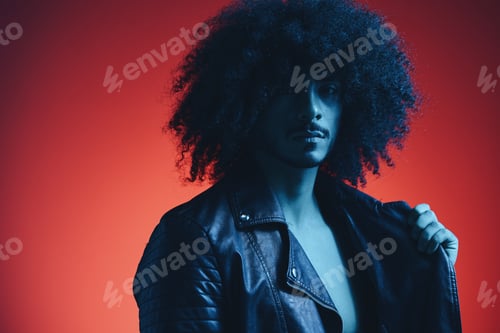 Preview: Portrait of fashion man with curly hair on red background multinational, colored light, black