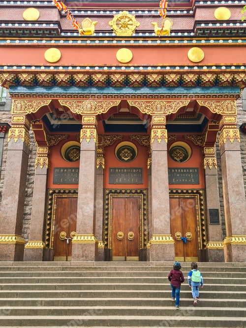 Preview: Two little kids walking up the stairs of aincient Buddhist temple.