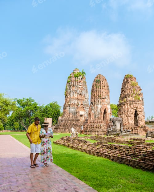 Preview: Ayutthaya, Thailand at Wat Mahathat, couple men and women with a hat and tourist map visiting
