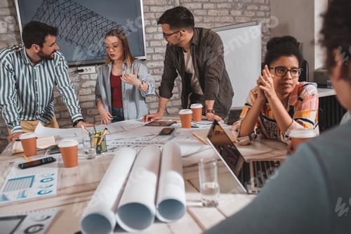 Preview: Group of modern business people discussing architectural designs in the creative office.