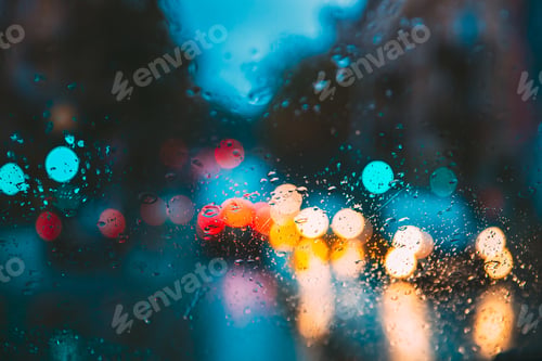Preview: Drops Of Rain Water In Night Or Evening Street Lights On Blue Glass Background. Street Bokeh Lights