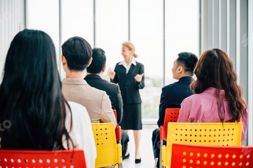 Preview: A confident senior corporate coach leads a seminar for a business team. The female director, CEO