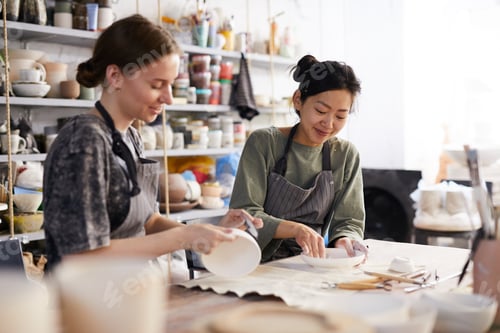 Preview: Positive women processing dishes in workshop