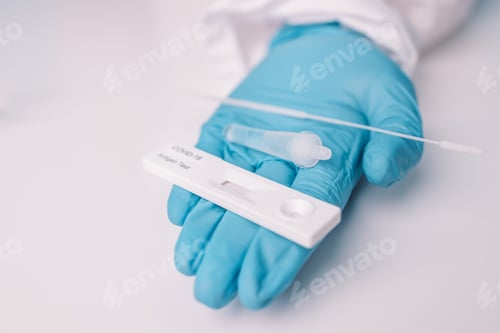 Preview: Antigen test procedure. Doctor in blue gloves holding rapid antigen test kit with negative result