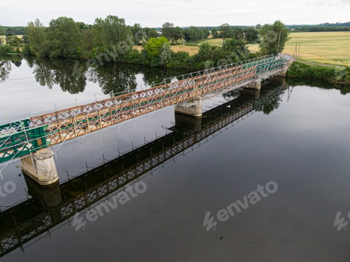 Preview: Scaffolding used for maintenance or restoration work on a small bridge over a large river the Cher