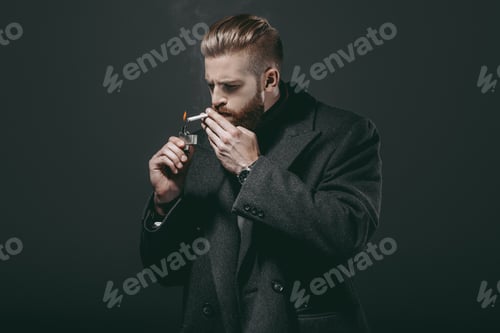 Preview: portrait of stylish man in jacket smoking cigarette isolated on black