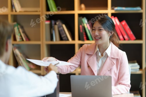Preview: Two young Asian business people discuss investment project working and planning strategy. Businessma