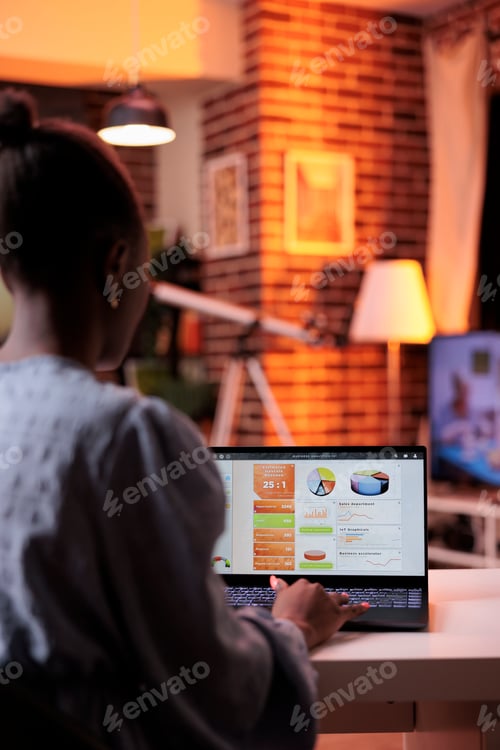 Preview: Business analyst looking at diagrams and pie charts on laptop screen