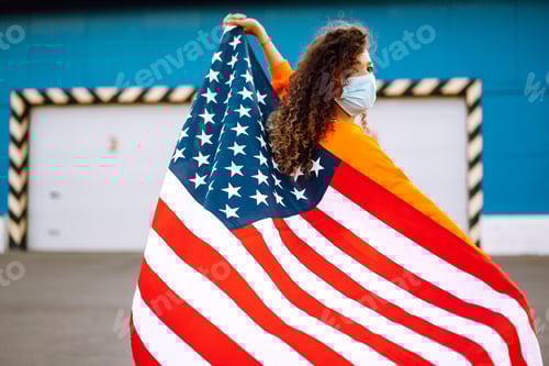 Preview: African woman with face mask posing with american flag.concept of preventing spread of epidemic.