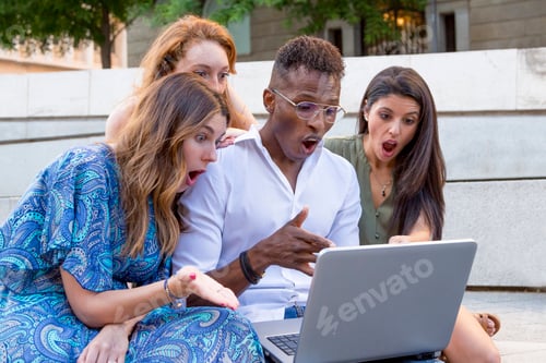 Preview: Group of friends looking at a laptop with a surprised face