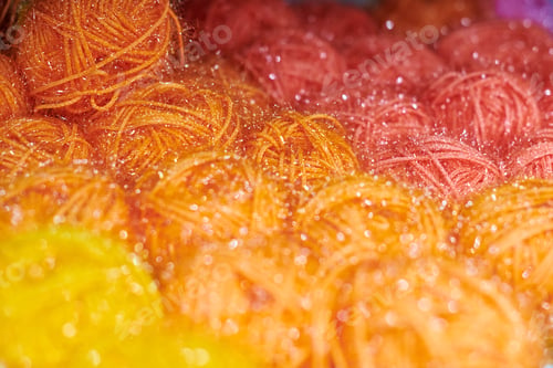 Preview: Colored orange and red yarn balls in knitting shop, macro