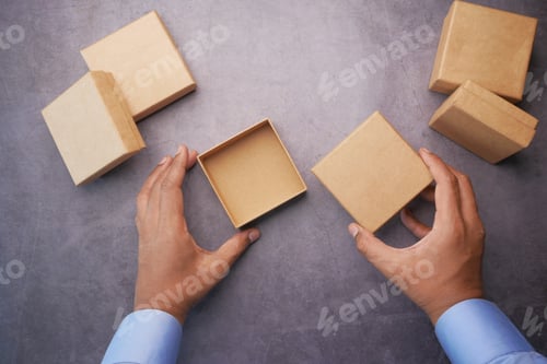 Preview: top view of person open a empty small gift box