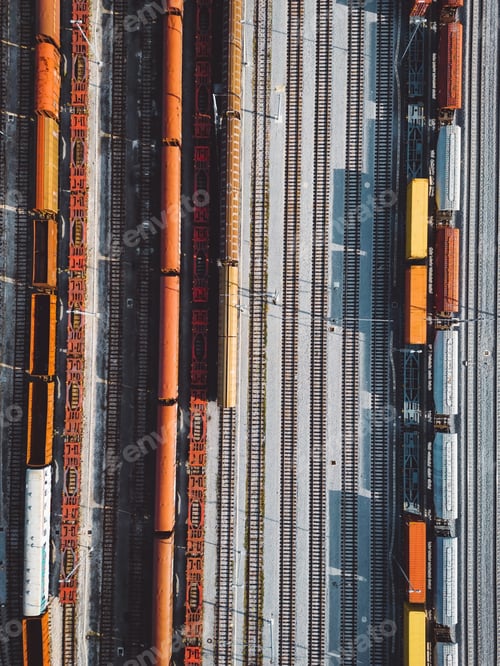 Preview: Birds eye view, vertical photo directly above cargo trains parked at the train station