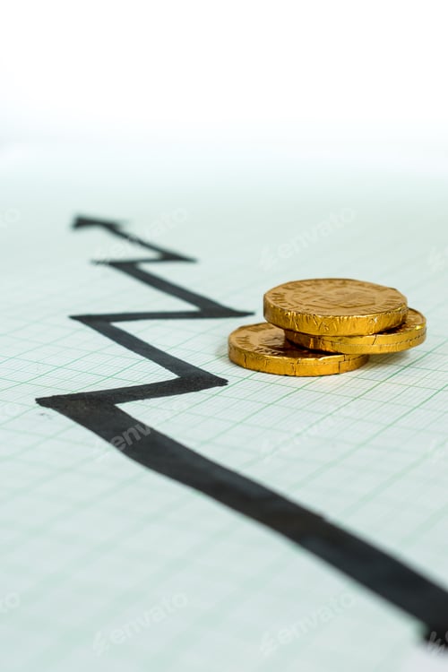 Preview: Vertical closeup shot of gold coins on a rising stock arrow