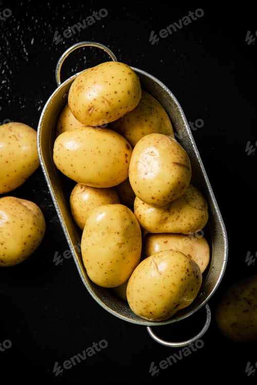 Preview: Fresh potatoes. On black background.
