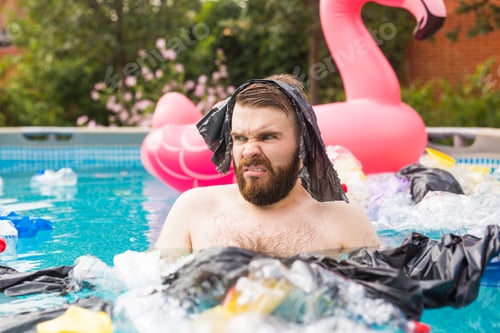 Preview: Ecology, plastic trash, environmental emergency and water pollution - shocked man swim in a dirty