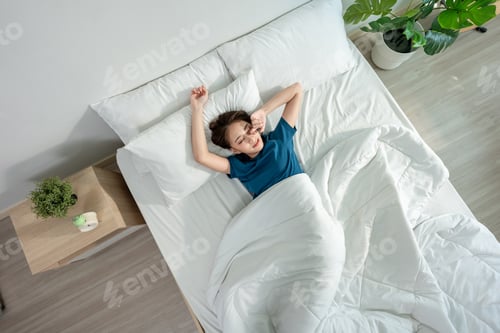 Preview: Asian beautiful girl in pajamas wake up in the morning with happy face.
