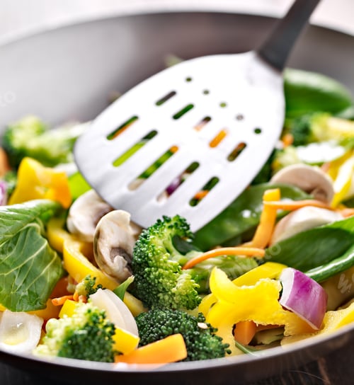 Preview: vegetarian wok stir fry with metal spatula.