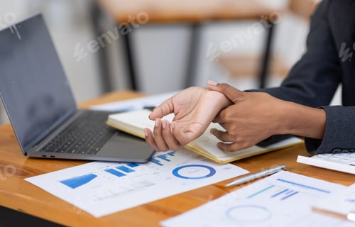 Preview: african american girl woman holding her wrist pain from using computer. Office syndrome hand pain